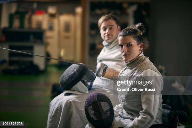 portrait of two wheelchair fencers - fechtsport stock-fotos und bilder