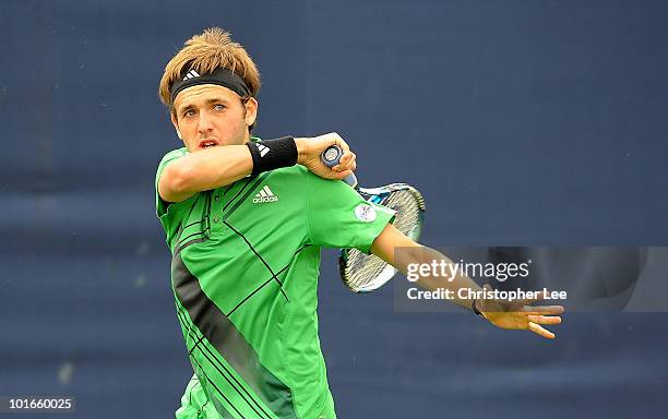 Daniel Evans of Great Britain in action against Dmitry Tursunov of Russia during the AEGON Championships Qualifiers at Queens Club on June 6, 2010 in...