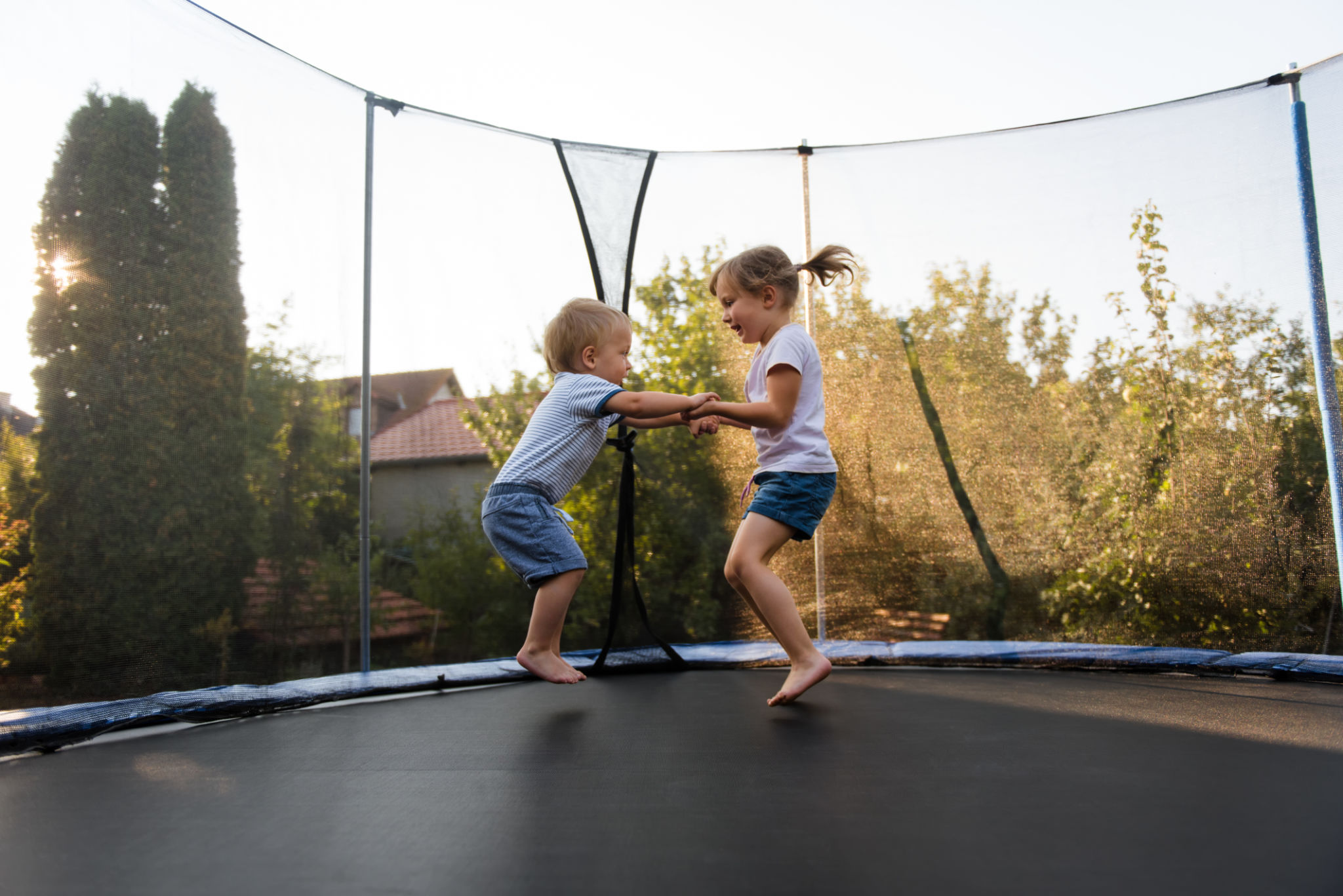 Little kids bouncing off the trampoline taut Little kids bouncing off the trampoline taut