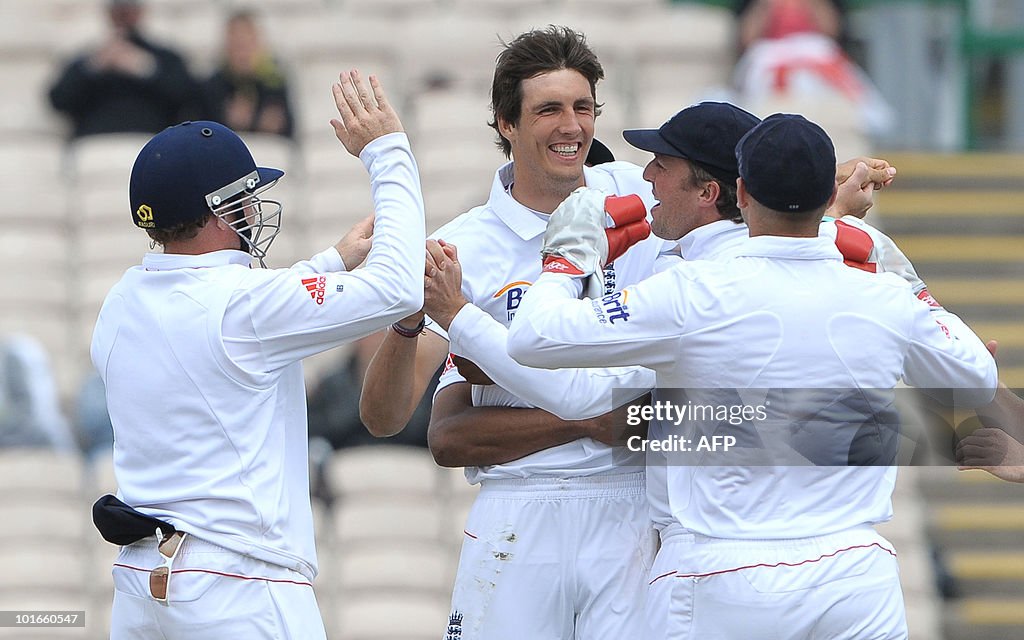 England's Steven Finn (C) celebrates aft