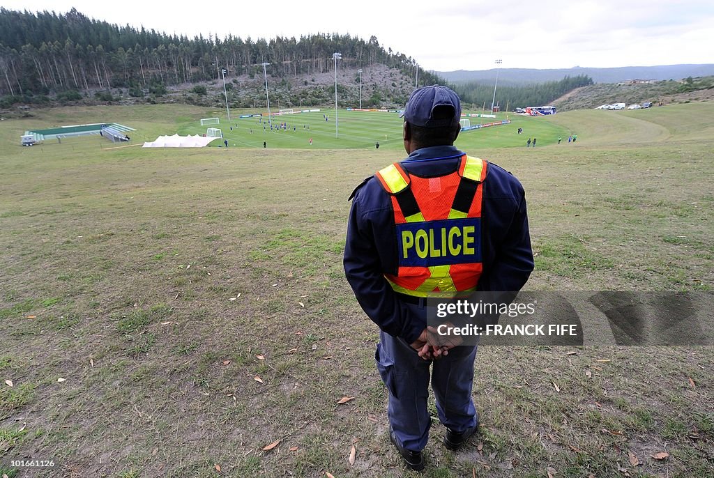 A South African policeman stands guard d