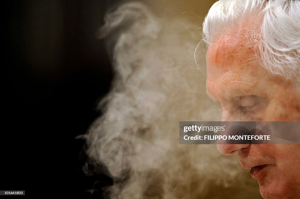 Pope Benedict XVI is shrouded in incense