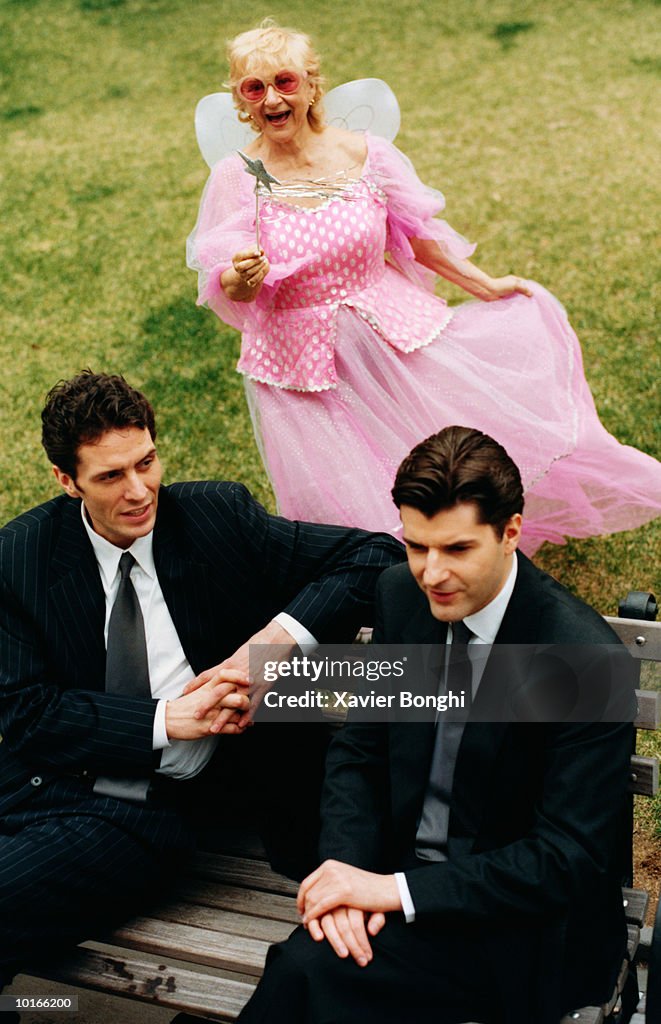 BUSINESSMEN ON BENCH WITH FAIRY GODMOTHER