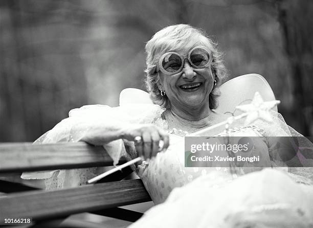 fairy godmother on city bench - men costume black and white stockfoto's en -beelden