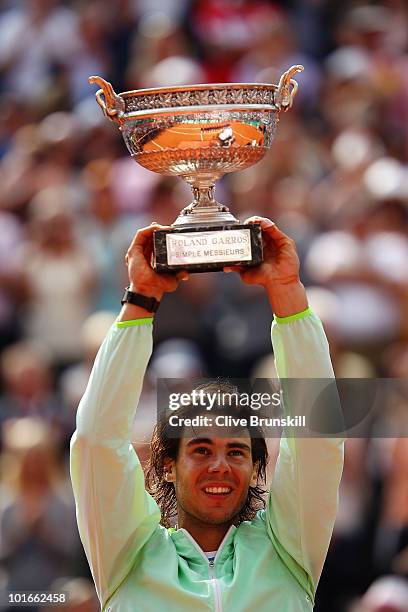 Rafael Nadal of Spain celebrates with the trophy after winning the men's singles final match between Rafael Nadal of Spain and Robin Soderling of...