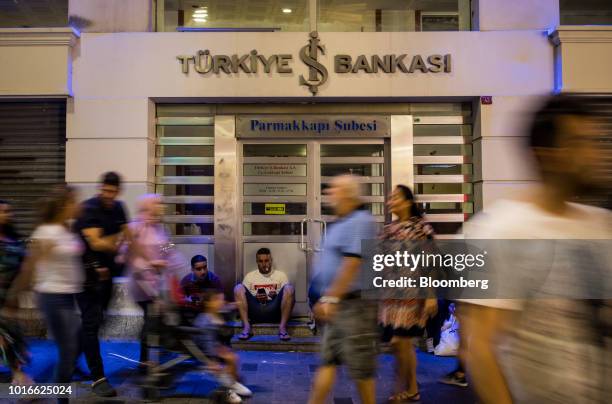 Pedestrians pass a closed branch of the Turkiye Is Bankasi AS, also known as Isbank, on Istiklal street in Istanbul, Turkey, on Monday, Aug. 13,...