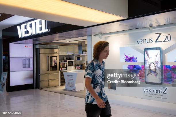 Pedestrian passes an advertisement for the Venus Z20 smartphone in the window of a Vestel Elektronik Sanayi ve Ticaret AS consumer electronics store...