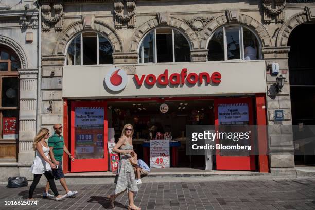 Pedestrians pass a Vodafone Group Plc communications store on Istiklal street in Istanbul, Turkey, on Tuesday, Aug. 14, 2018. President Recep Tayyip...