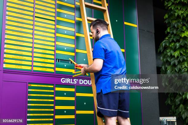 man up ladder changing order of play outside tennis court, wimbledon, uk - the championships wimbledon 2018 stock pictures, royalty-free photos & images