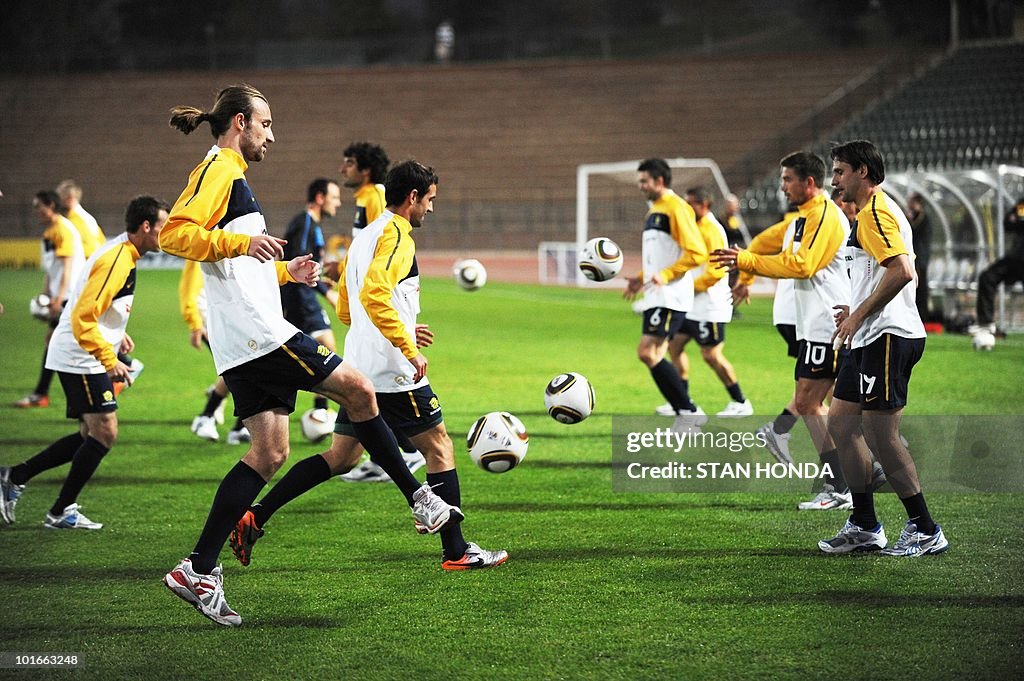 Australia's striker Josh Kennedy (L) tak