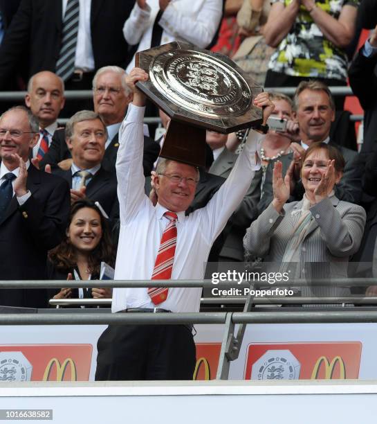 Manchester United manager Sir Alex Ferguson holds the trophy aloft after the FA Community Shield match between Chelsea and Manchester United at...