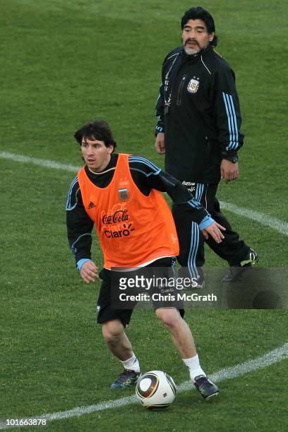 Argentina's head coach Diego Maradona watches on as Lionel Messi looks to pass during a team training session on June 6, 2010 in Pretoria, South...