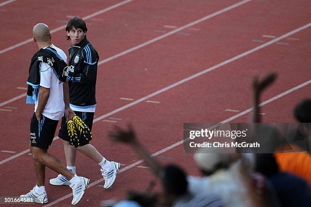 Juan Veron and Lionel Messi of Argentina's national football team look back at the crowd during a team training session on June 6, 2010 in Pretoria,...