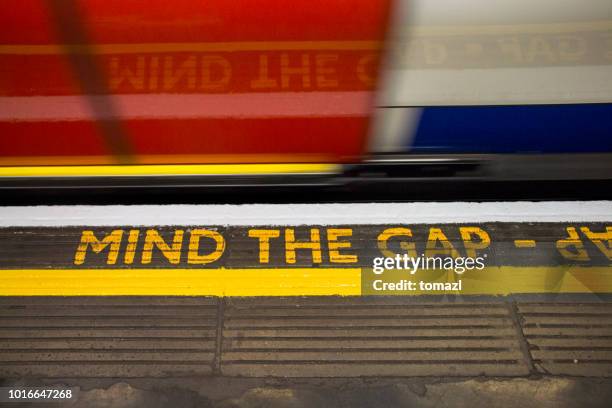 mind the gap sign on london underground - missing teeth stock pictures, royalty-free photos & images