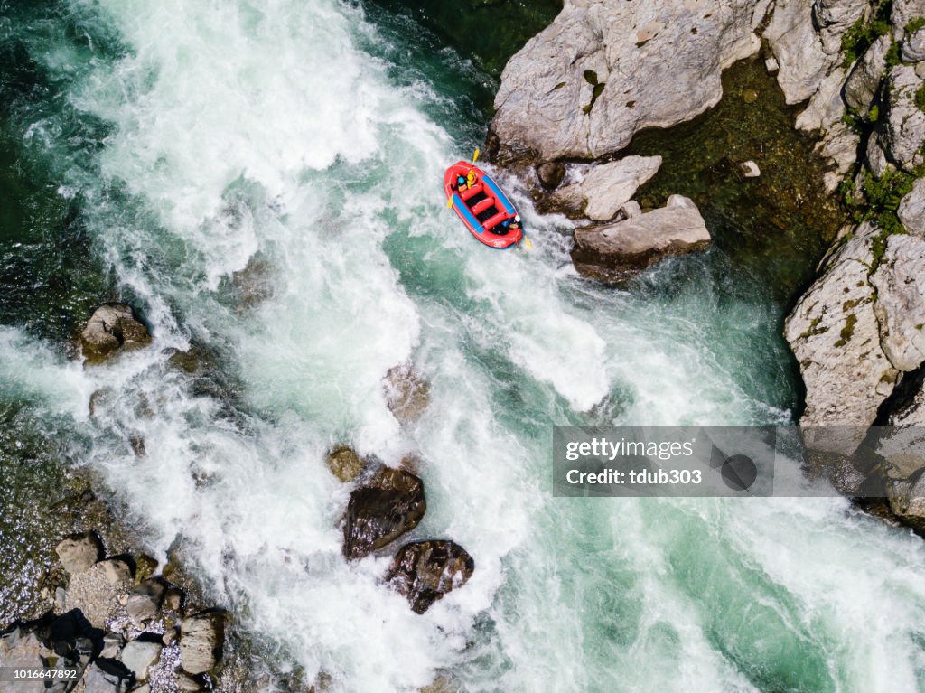Vista aérea de un grupo de hombres y mujeres aguas blancas rafting en el río