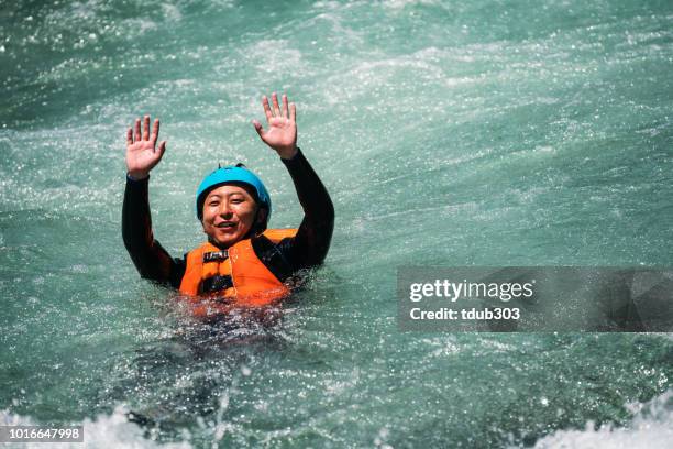 man floating down a river with a life jacket on - life jacket stock pictures, royalty-free photos & images