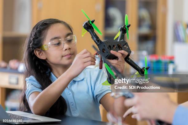 middle school student tweaks quadcopter model - preteen girl models stock pictures, royalty-free photos & images