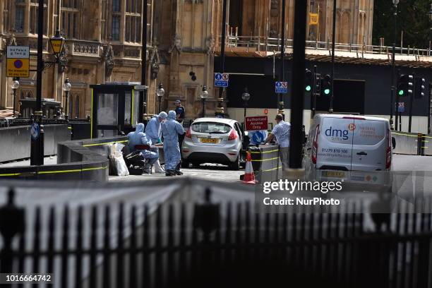 General view of forensic officers with the vehicle that crashed into security barriers, injuring a number of pedestrians early this morning, outside...