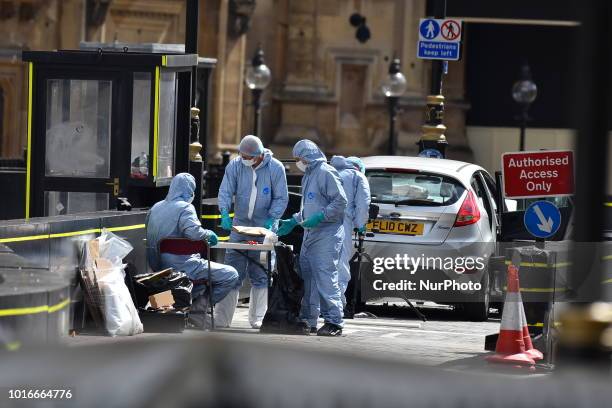 General view of forensic officers with the vehicle that crashed into security barriers, injuring a number of pedestrians early this morning, outside...