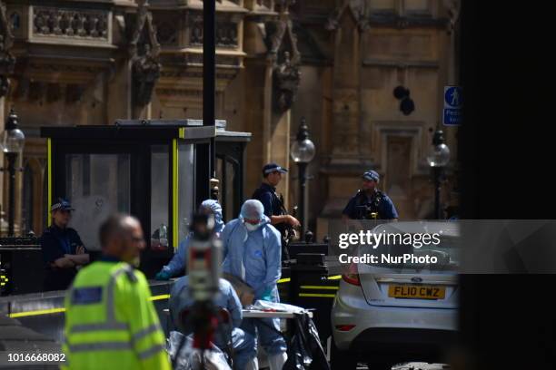 General view of forensic officers with the vehicle that crashed into security barriers, injuring a number of pedestrians early this morning, outside...