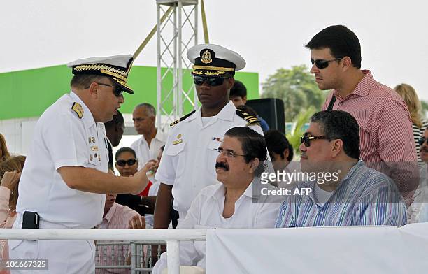 Dominican Chief of Staff Luis Lajara Sola speaks with Honduran former President Manuel Zelaya at Don Diego port in Santo Domingo on June 6, 2010. The...