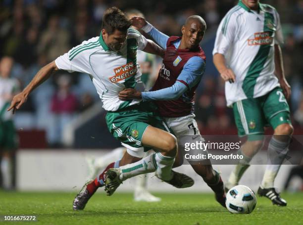 Markus Katzer of SK Rapid Vienna and Ashley Young of Aston Villa in action during the UEFA Europa League Play Off second leg match between Aston...