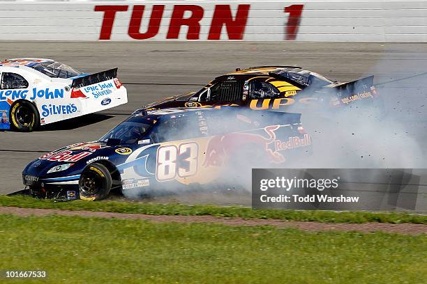 Casey Mears, driver of the Red Bull Toyota, spins out off the track after an incident with David Ragan, driver of the UPS Ford, during the NASCAR...