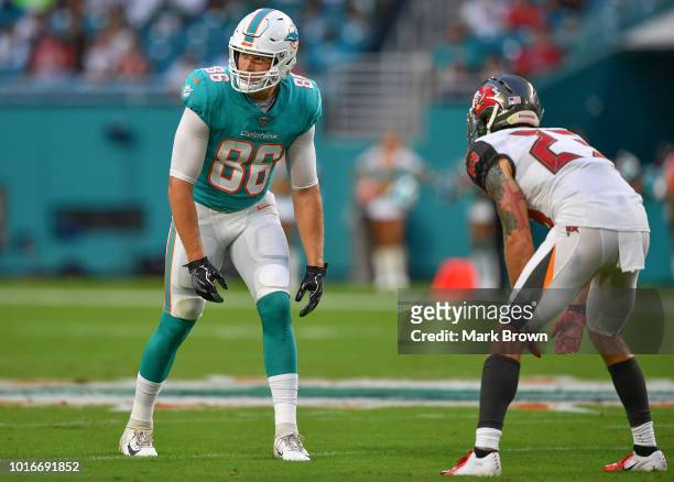 Mike Gesicki of the Miami Dolphins lines up to run a route against Chris Conte of the Tampa Bay Buccaneers in the first quarter during a preseason...