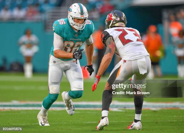 Mike Gesicki of the Miami Dolphins lines up to run a route against Chris Conte of the Tampa Bay Buccaneers in the first quarter during a preseason...