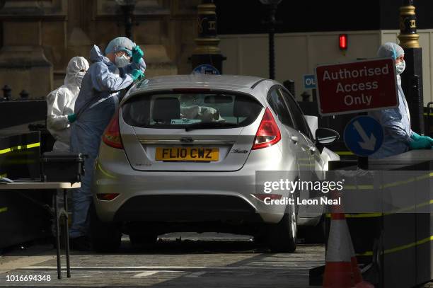 General view of forensic officers working on the vehicle that crashed into security barriers, injuring a number of pedestrians early this morning,...