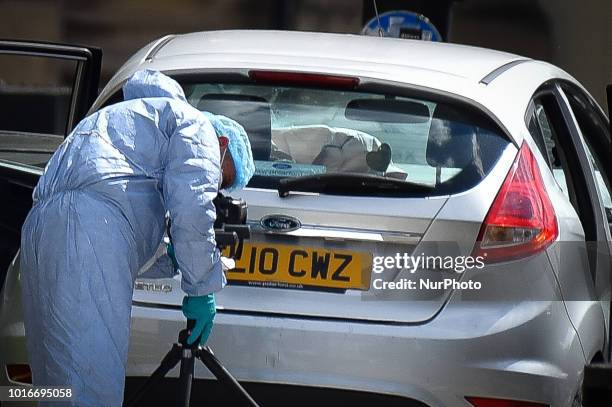 General view of forensic officers with the vehicle that crashed into security barriers, injuring a number of pedestrians early this morning, outside...