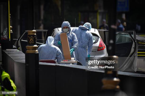 General view of forensic officers with the vehicle that crashed into security barriers, injuring a number of pedestrians early this morning, outside...