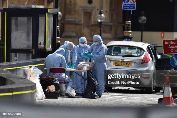 General view of forensic officers with the vehicle that crashed into security barriers, injuring a number of pedestrians early this morning, outside...