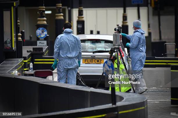 General view of forensic officers with the vehicle that crashed into security barriers, injuring a number of pedestrians early this morning, outside...