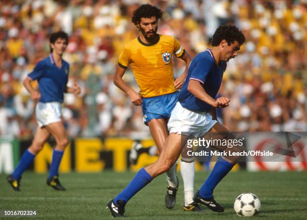 July 1982 - FIFA World Cup - Italy v Brazil - Giuseppe Bergomi of Italy on the ball, watched by Socrates of Brazil -