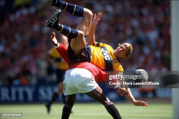 August 1998 - FA Charity Shield - Arsenal v Manchester United - Tony Adams of Arsenal falls over the back of Andy Cole of United -