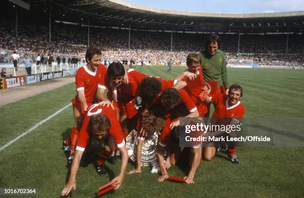 August 1979 Wembley - Football Association Charity Shield - Arsenal v Liverpool - Kenny Dalglish pushes his teammates over as they pose with the...