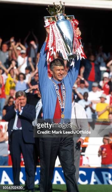 May 2004 - Premiership Football - Arsenal v Leicester City - Arsenal manager Arsene Wenger holds the Premiership trophy aloft in celebration -