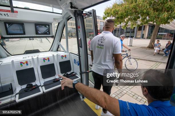 An operator stands in the door of an electric autonomous bus while a passenger waits on August 14, 2018 in Mainz, Germany. Called EMMA, the bus is...