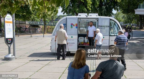 Passenger talk to an operator in an electric autonomous bus on August 14, 2018 in Mainz, Germany. Called EMMA, the bus is made by Navya and will...