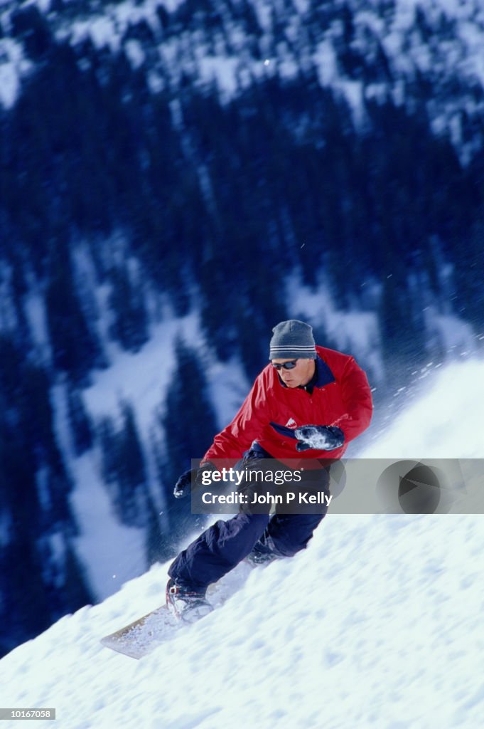 Man snowboarding, Snowmass, Colorado, USA