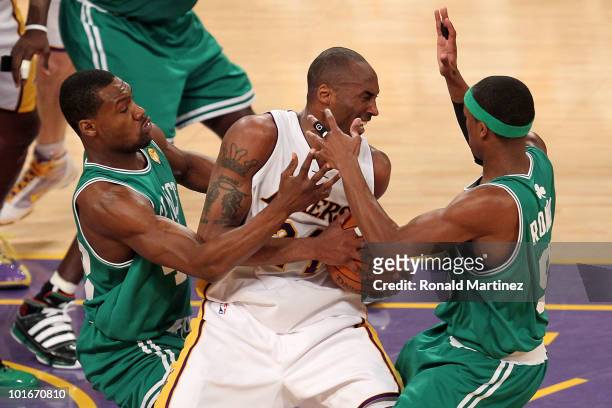 Kobe Bryant of the Los Angeles Lakers attempts to control the ball against TOny Allen and Rajon Rondo of the Boston Celtics in the first half of Game...