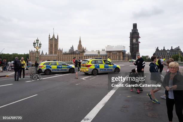 Police officers secure Westminster Bridge going towards the Houses of Parliament after a vehicle crashed into security barriers, injuring a number of...