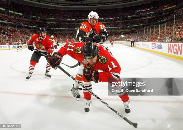 John Madden of the Chicago Blackhawks is checked by Chris Pronger of the Philadelphia Flyers during the second period of Game Five of the 2010 NHL...