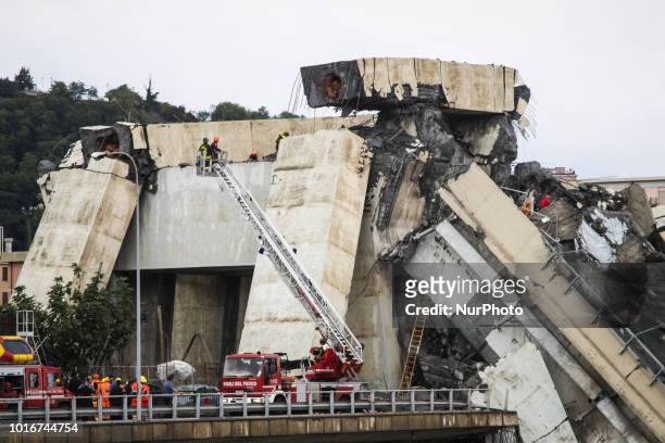 Rescue workers at the Morandi bridge which collapsed on August 14, 2018 in Genoa, Italy. At at least 22 people have died when a large section of...