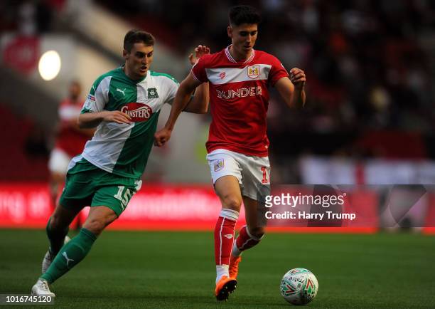 Callum O'Dowda of Bristol City looks to break past Conor Grant of Plymouth Argyle during the Carabao Cup First Round match between Bristol City and...