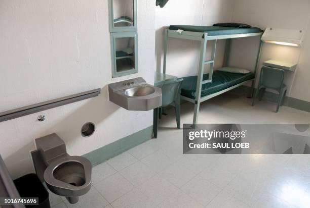 Bunk bed, desks, toilet and sink inside a cell are seen at the Caroline Detention Facility in Bowling Green, Virginia, on August 13, 2018. - A former...