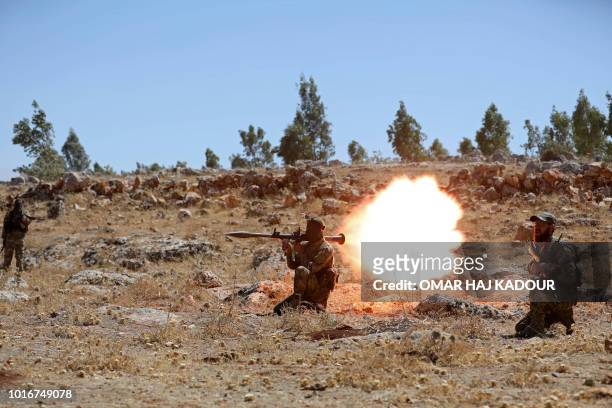 Syrian fighter fires a rocket-propelled grenade as he attends a mock battle in anticipation of an attack by the regime on Idlib province and the...