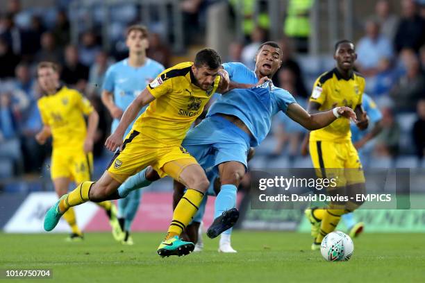 Oxford United's John Mousinho and Coventry City's Maxime Biamou battle for the ball Oxford United v Coventry City - Carabao Cup - First Round -...