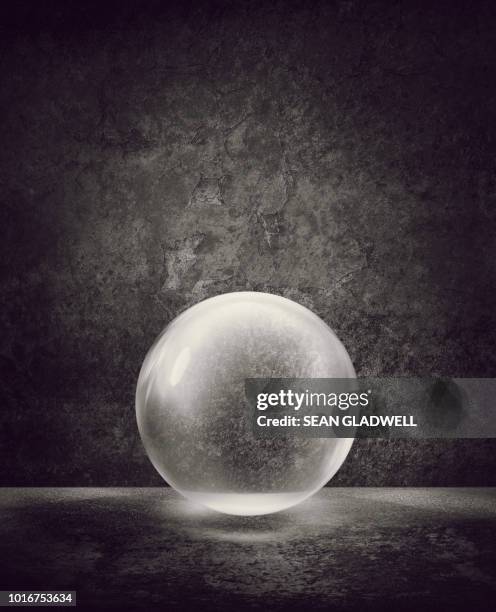 transparent sphere against wall with peeling plaster - magic ball stock-fotos und bilder